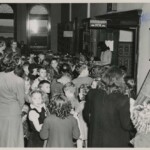 A group of children at the registration desk of the Cossitt Library