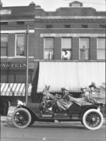 Suffrage parade on S. Main Street. Vehicle carrying women with sign, "Votes For Women".