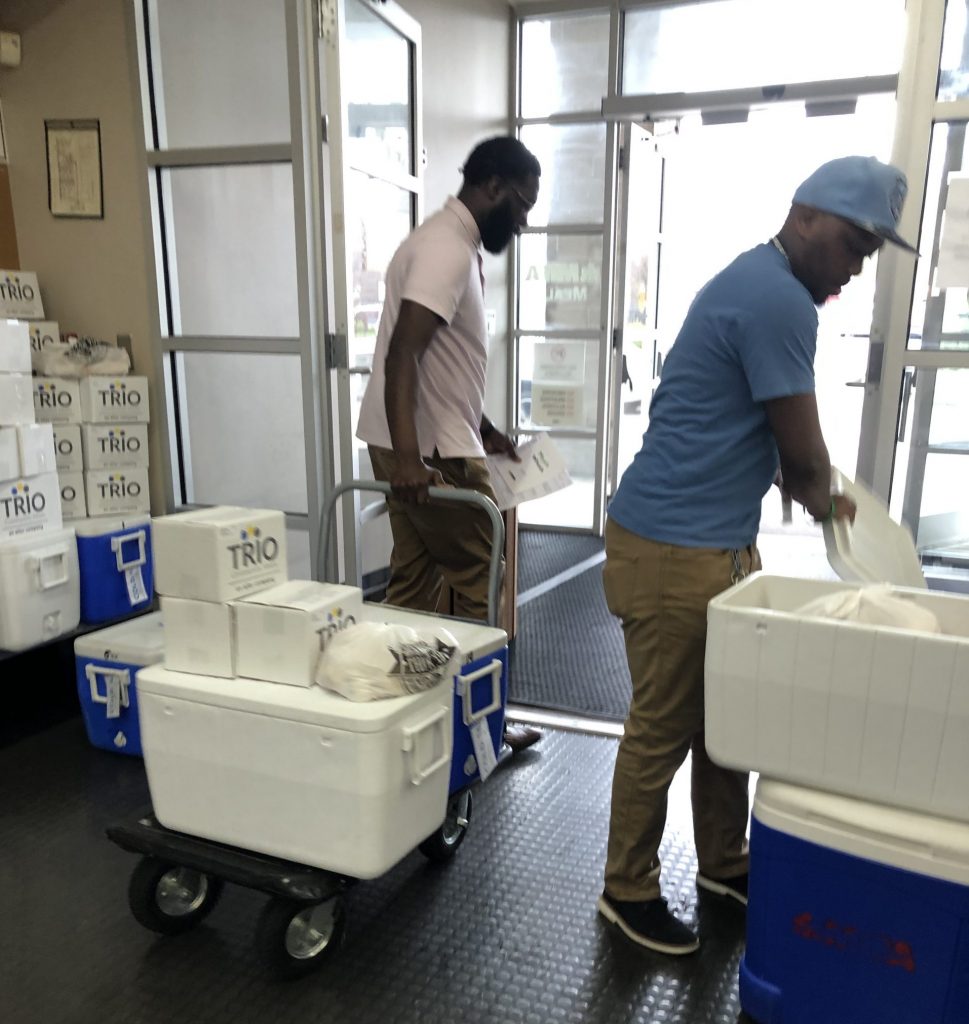 Two library staffers helping to pack and deliver meals for Meals on Wheels.